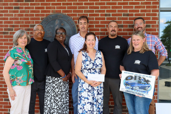 Image of Garage Band Charities founders standing with all the individuals representing charities who received donations from the organization.