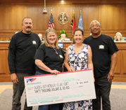 Image of Garage Band Charities presenting a check to Children & Youth Partnership for Dare County.