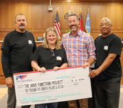 Garage Band Charities founders present a check for $2,500 to The Wave Function Project.