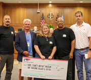 Garage Band Charities presents a check for $1,000 to the Dare County Airport Museum.