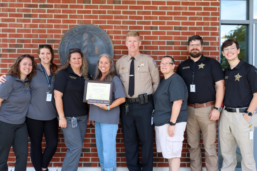Elizabeth Farmer stands with her 911 Communications Center colleagues who attended the presentation.