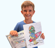 A young boy smiles as he holds up a drawing of the Professor Faucet character along with his winning certificate.
