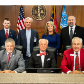 Image of the seven commissioners seated together