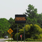 Roadway leading the NC Hwy. 12 with an electronic traffic sign that reads "Mandatory Evacuation"