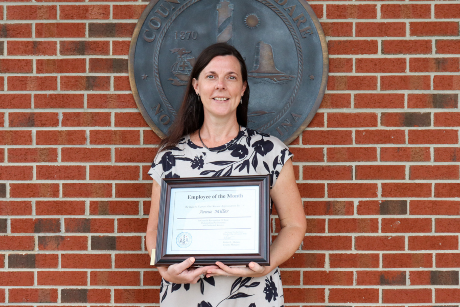 Public Health School Nurse Anna Miller holds her Employee of the Month certificate.