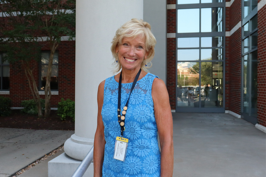 Image of Debbie Dutton wearing her badge with service pins.