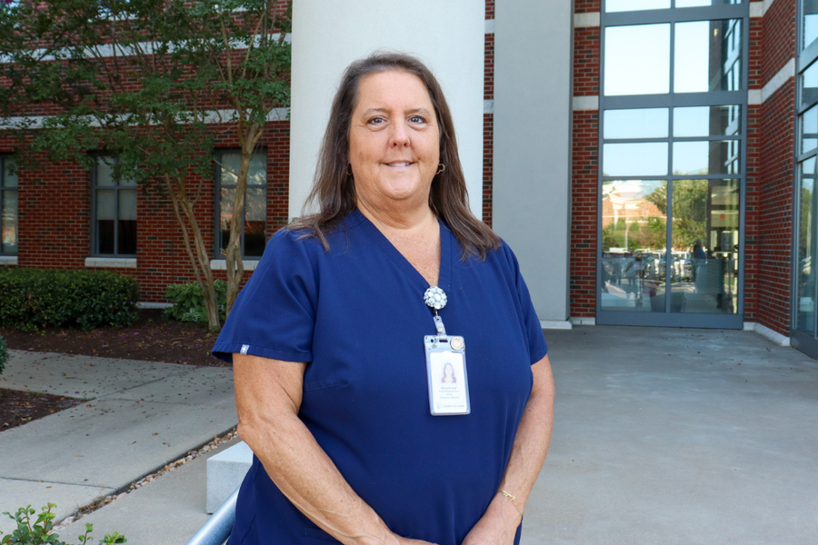 Image of Monica Creef wearing a nursing outfit and a badge.
