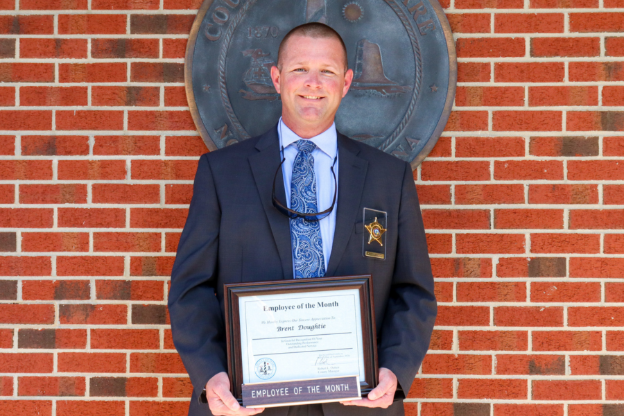 Dare County Deputy Sheriff Master Officer Brent Doughtie holde his Employee of the Month certificate.