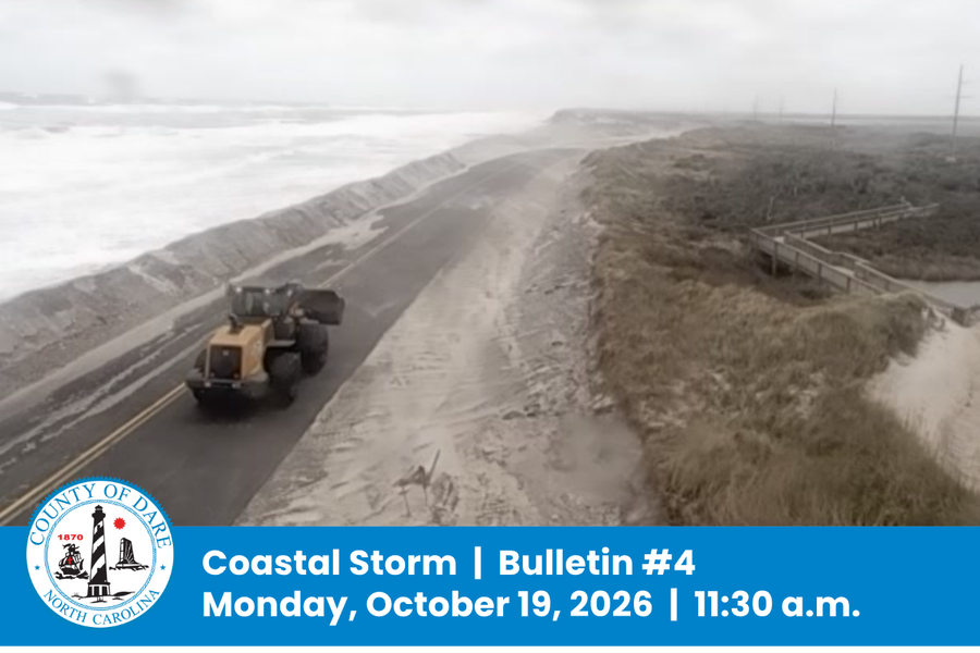 Aerial image of bulldozer pushing sand off of NC Hwy. 12. Heading: Coastal Storm  |  Bulletin #4 Monday, October 19, 2026  |  11:30 a.m.
