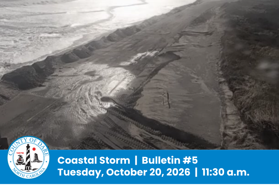 Aerial image of water and sand covering NC Hwy. 12. Heading: Coastal Storm |Bulletin #5 Tuesday, October 20, 2026 | 11:30 a.m.