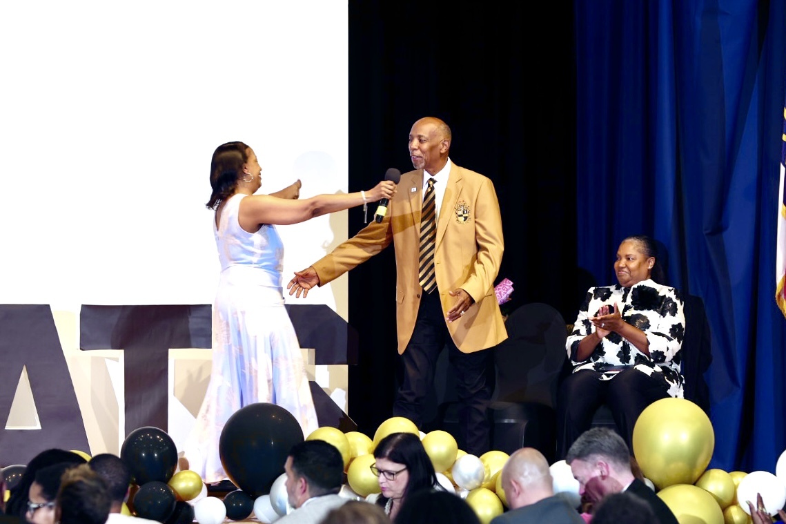 Dr. Fenner congratulating Dr. Connelly onstage