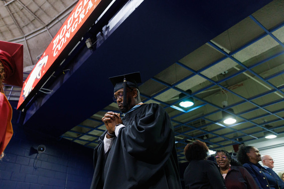 DBHS Principal Kenneth Williams praying