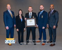Chief Capps and members of the Knightdale Police Department Receiving CALEA accreditation certificate. 