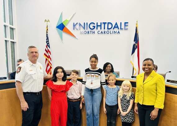 Knightdale Mayor Jessica Day poses with Fire Chief Loren Cone and winners of the Fire Station Art Contest