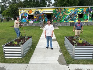 Mason Privette and the raised garden beds at Harper Park