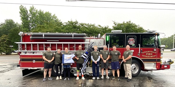 Knightdale Public Safety Employees Stand in front of a fire truck before the Law Enforcement Torch Run