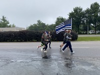 Torch Run Participants running with the flag