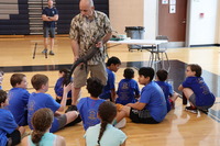 Camp PRIDE Students touch a crocodile