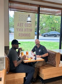 Knightdale Police Department members talk to residents at Coffee with a Cop event at Knightdale Bojangles