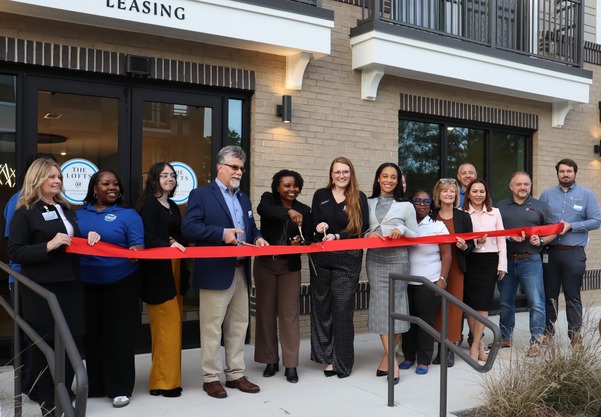 Mayor Jessica Day leads the ribbon cutting ceremony for The Lofts at Knightdale Station