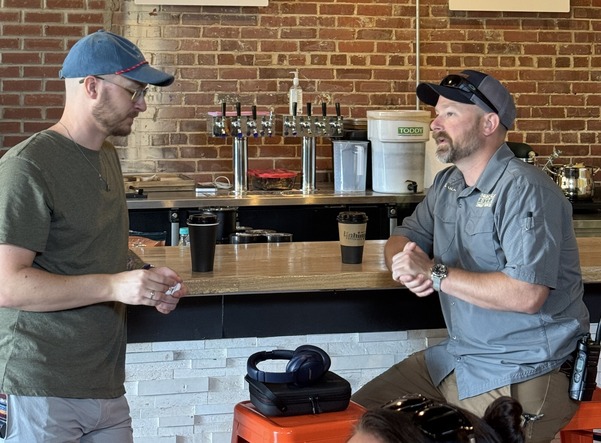 KPD Officer talks to resident at Unhinged Coffee