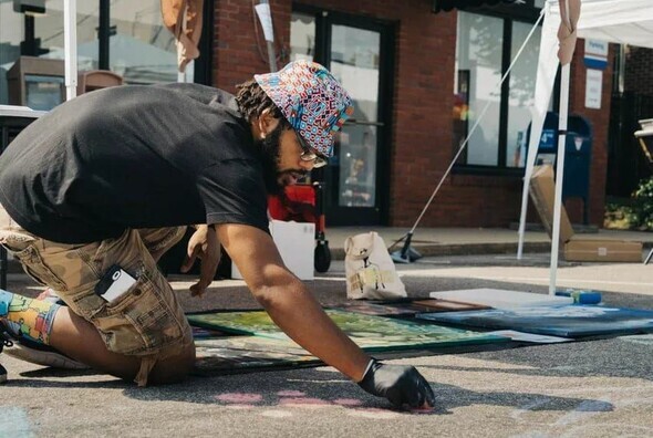 Artist Justin Perry working on chalk art 