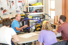 Group of people fixing a bike