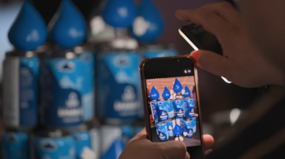 someone taking a picture of cans of sparkling water