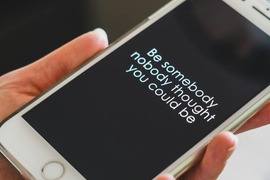 mobile phone with text that says "be somebody nobody thought you could be"