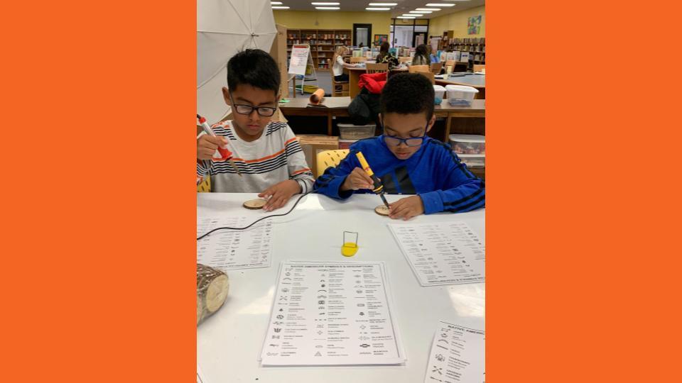 Students doing wood burning