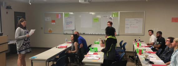 Image of Classroom with Facilitator at front and Adult Learners Seated 