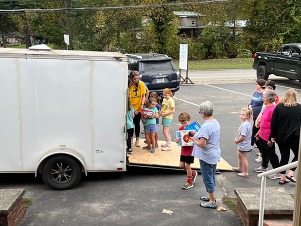 heather smith and students loading supplies