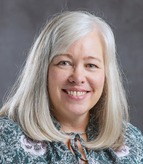 Headshot of Donna Murray, middle-aged white woman with shoulder-length gray hair.