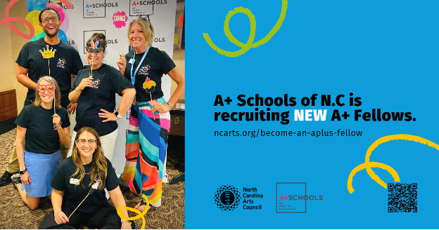 A group of teachers smiling at the camera with fun props for a photobooth