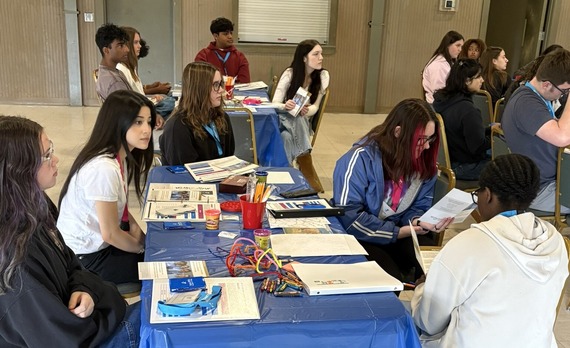 Image of teens at tables working together