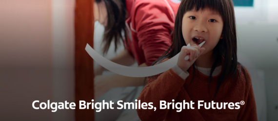 young child brushing teeth