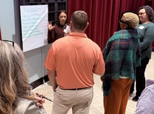 Picture of teachers in front of poster