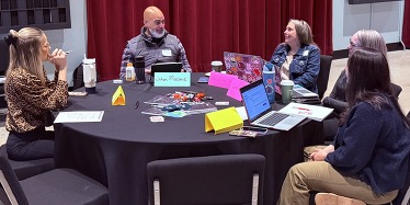 Picture of educators talking around a table