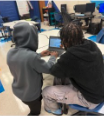 Students working together at a computer