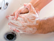 Hand washing with soap under tap water
