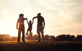 Happy family walking in a meadow