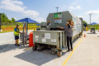 Employees operating the compactor