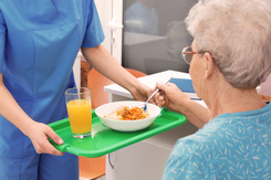 Elderly woman eating in nursing home