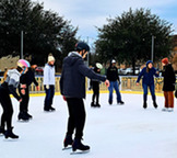 Group of ice skaters in a circle on the rink 