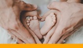 Parents hand and baby feet