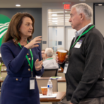Chair Melissa Merrell speaking with attendee