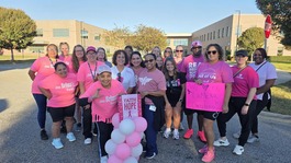 group of employees wearing pink for breast cancer awareness