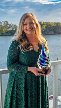 Union County Public Communications Director Liz Cooper holding award for North Carolina Communicator of the Year