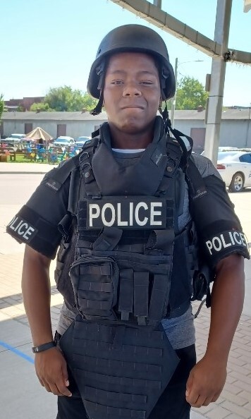 Teens wearing police equipment