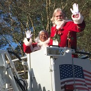 Santa and mrs. claus riding in parade